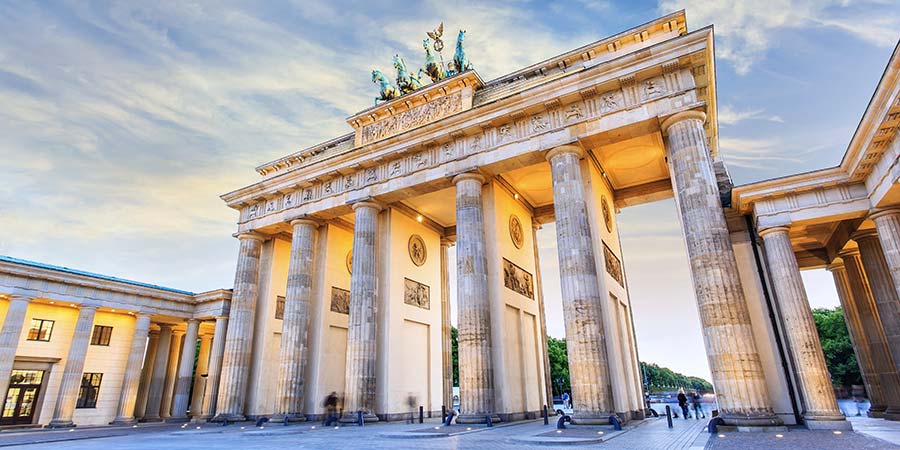 Berlin’s iconic Brandenburg Gate towers above passing tourists.