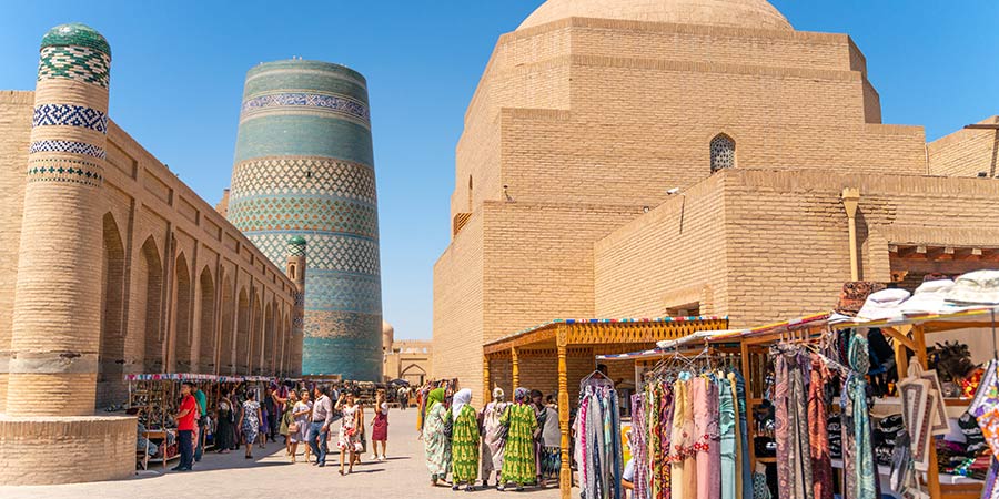 The vibrant city of Khiva in Uzbekistan, full of colourful fabric and clothing stalls.